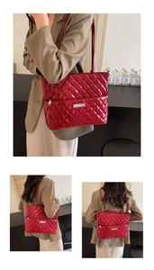 Detail of red quilted patent leather tote showing convertible straps and silver hardware