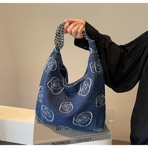 Blue denim hobo shoulder bag with white rose embroidery and silver metal chain strap