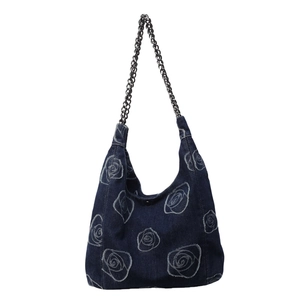Deep blue denim hobo bag with white rose floral patterns and silver metal chain strap