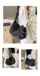 Dettaglio borsa di jeans nero lavato vintage con cerniere e tracolla larga