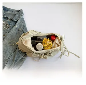 Interior view showing the large capacity of the beige nylon drawstring commuter bag