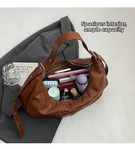 Top view of spacious interior in brown vintage leather tote showing organized daily items