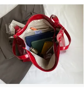 Interior view of red patent leather tote showing laptop storage and multi-pocket layout