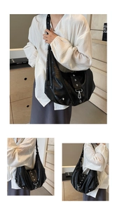 Detail of silver star rivets and metal buckle on the black vintage soft leather tote bag