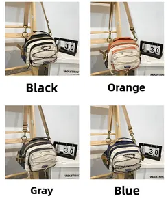 Multi-color outdoor crossbody bags in black, orange, grey and blue with elastic cords