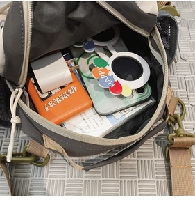 Detailed interior of a large canvas messenger bag showing high storage capacity and lining