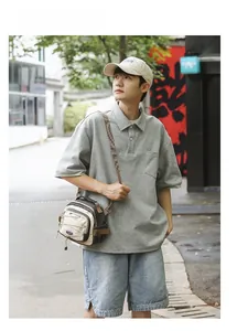 Outdoor male model wearing a beige and brown canvas crossbody bag with bungee cords