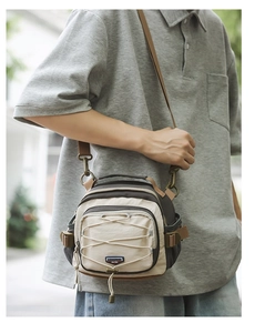 Detail of multi-functional crossbody bag with elastic cord and adjustable strap