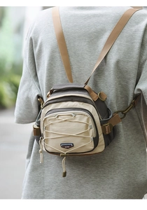 Close-up of a versatile mini hiking bag with crossbody straps and elastic bungee detail