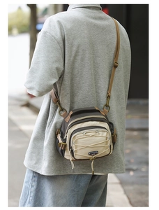 Close-up of durable canvas crossbody bag featuring elastic drawstring and adjustable strap