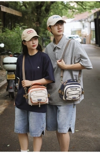 Outdoor shot of cross-body messenger bags with toggle cords and multi-pocket details