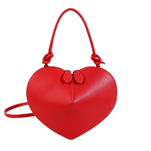 Glossy red heart-shaped crossbody bag with knotted handle and dual zippers