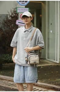Close-up of utility messenger bag featuring nylon patchwork and elastic drawstring details