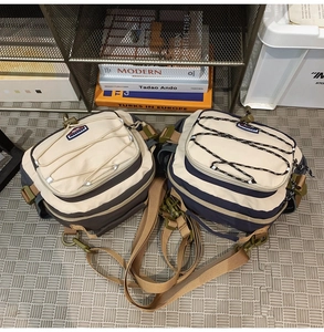 Macro shot of two multi-functional nylon messenger bags with bungee cords and buckles