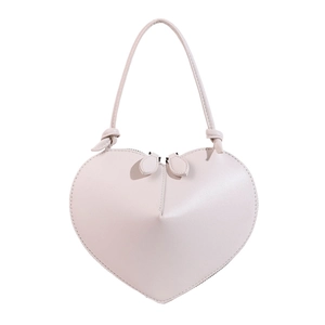 Detailed view of heart-shaped handbag with premium leather texture and zipper puller