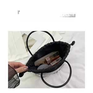 Top view of silver rhinestone bucket bag showing internal space for phone and makeup