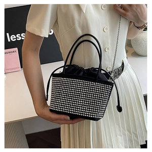 Close-up of black bucket bag with silver rhinestones, drawstring liner and chain strap