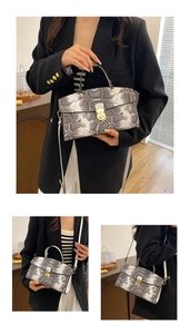Detail of snake skin print tote bag featuring gold buckle and detachable shoulder strap