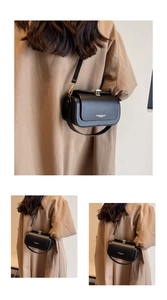 Minimalist black leather shoulder bag featuring a gold metal buckle and urban fashion logo
