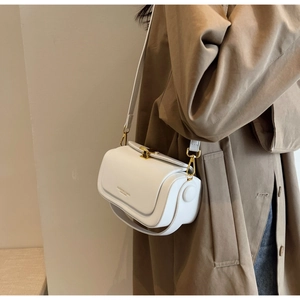 Detail of white leather shoulder bag featuring gold clasp and Fashion & Bags engraving