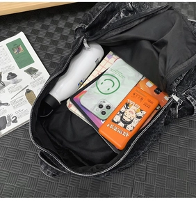 Spacious black snowflake denim backpack showing large interior capacity for travel items