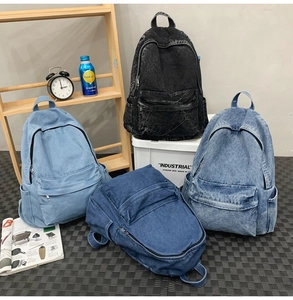 Macro shot of durable denim backpacks in four distinct wash colors and textures