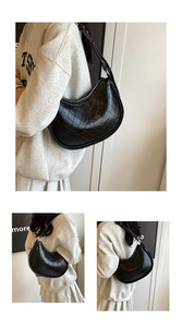 Detail view of black quilted faux leather hobo bag with adjustable strap and metal zipper