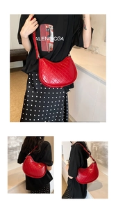 Close-up of bright red quilted shoulder bag showing diamond stitching and leather texture
