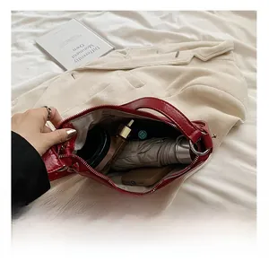 Top view of red quilted bag interior showing large capacity for umbrella and phone