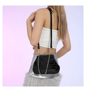 Nahaufnahme der schwarzen Krokodilmuster Kussverschluss Schultertasche mit Kette.