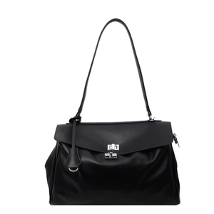 Black leather tote bag with silver buckle and shoulder strap on white background