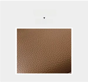 Macro close-up of brown lychee grain leather texture on a vintage tote bag
