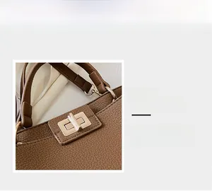 Detail macro of brown pebble leather tote with gold twist lock and fine stitching