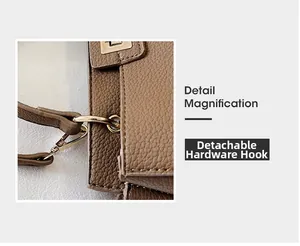 Detail magnification of detachable golden metal hook on brown lychee leather tote bag