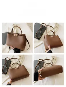 Detail view of brown lychee texture handbag with golden twist lock and versatile straps