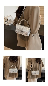 Detail of silver quilted handbag featuring pearl handle and metal chain shoulder strap