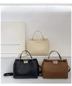 Close-up of retro tote bags in cream, black, and tan showing leather texture and hardware