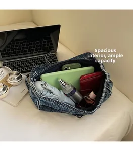 Spacious interior of blue denim tote bag filled with umbrella, tablet and daily essentials
