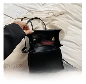Internal view of black leather polka dot backpack showing zipper compartment and spacious storage