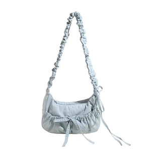 Chic light blue pleated canvas crossbody bag with decorative bow and accordion straps