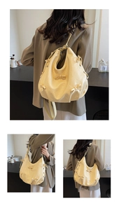 Close-up of pleated cream yellow tote bag showing textured leather and bow detailing