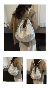 Detail of silver metallic tote with bow accents and natural crinkled texture
