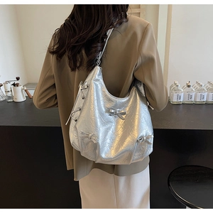 Silver metallic Hobo bag with detailed pleats and decorative bows on shoulder