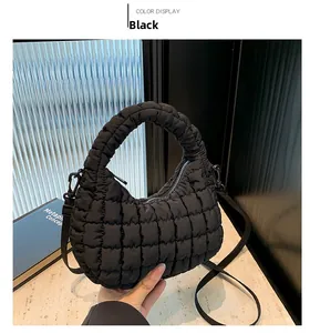 Détail d'un sac cabas noir matelassé avec texture douce et bandoulière élégante