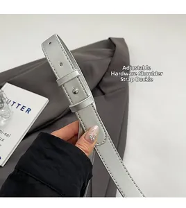 Detail of adjustable silver shoulder strap with metallic buckle and precise stitching