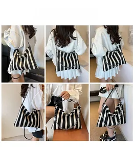 Detailed views of striped canvas tote bag showing versatile chain and leather straps