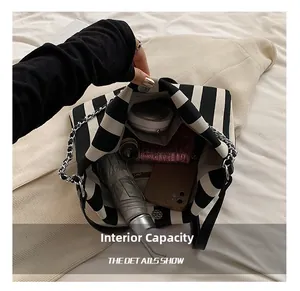 Detail shot of black and white striped canvas bag interior showing large storage capacity