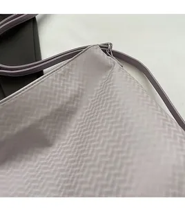 Close-up of light purple wavy textured fabric and neat stitching on a large tote bag