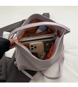 Detail view of large lavender tote interior with organized compartments for daily essentials