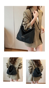 Detail of black woven leather tote with golden heart studs showing backpack conversion